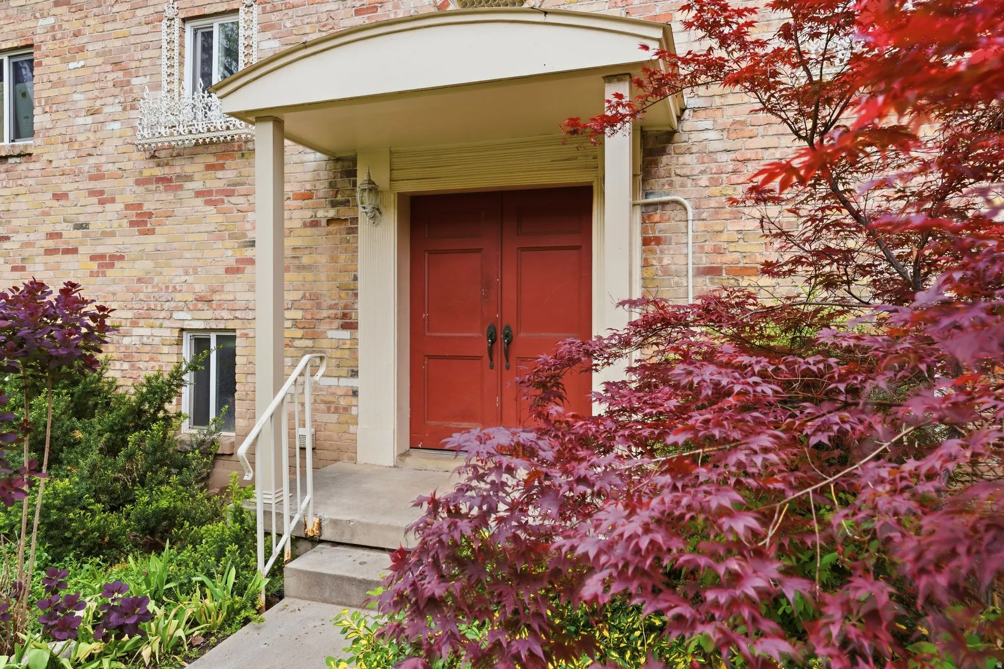 View of exterior entry with brick siding