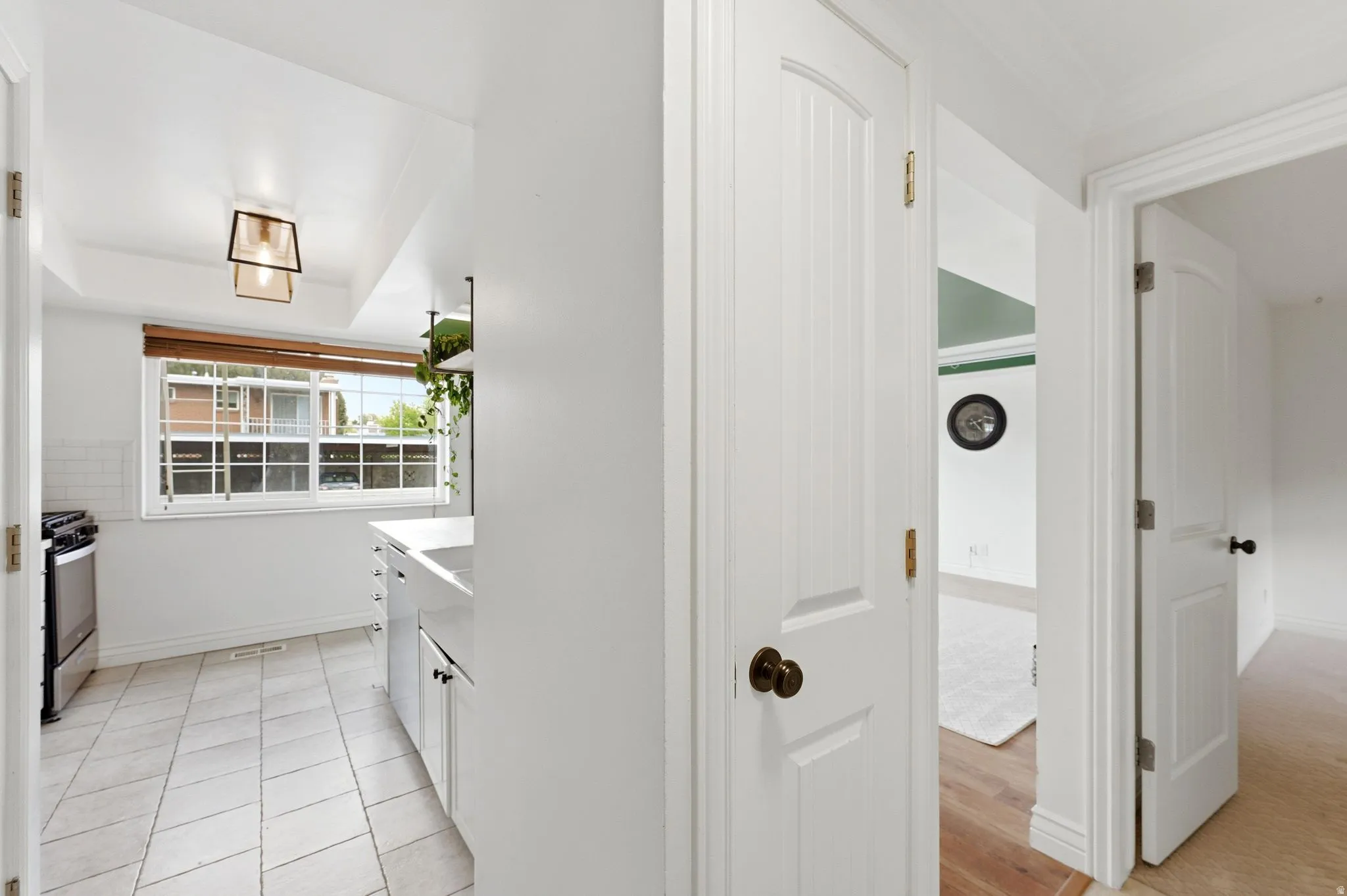Kitchen featuring light countertops, white cabinetry, and stainless steel electric range oven