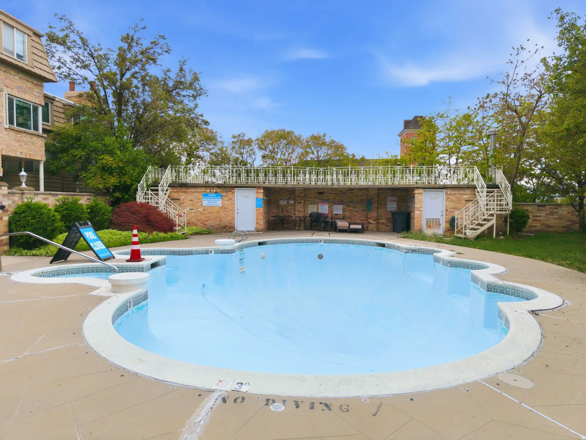 Community pool featuring stairs and a patio area