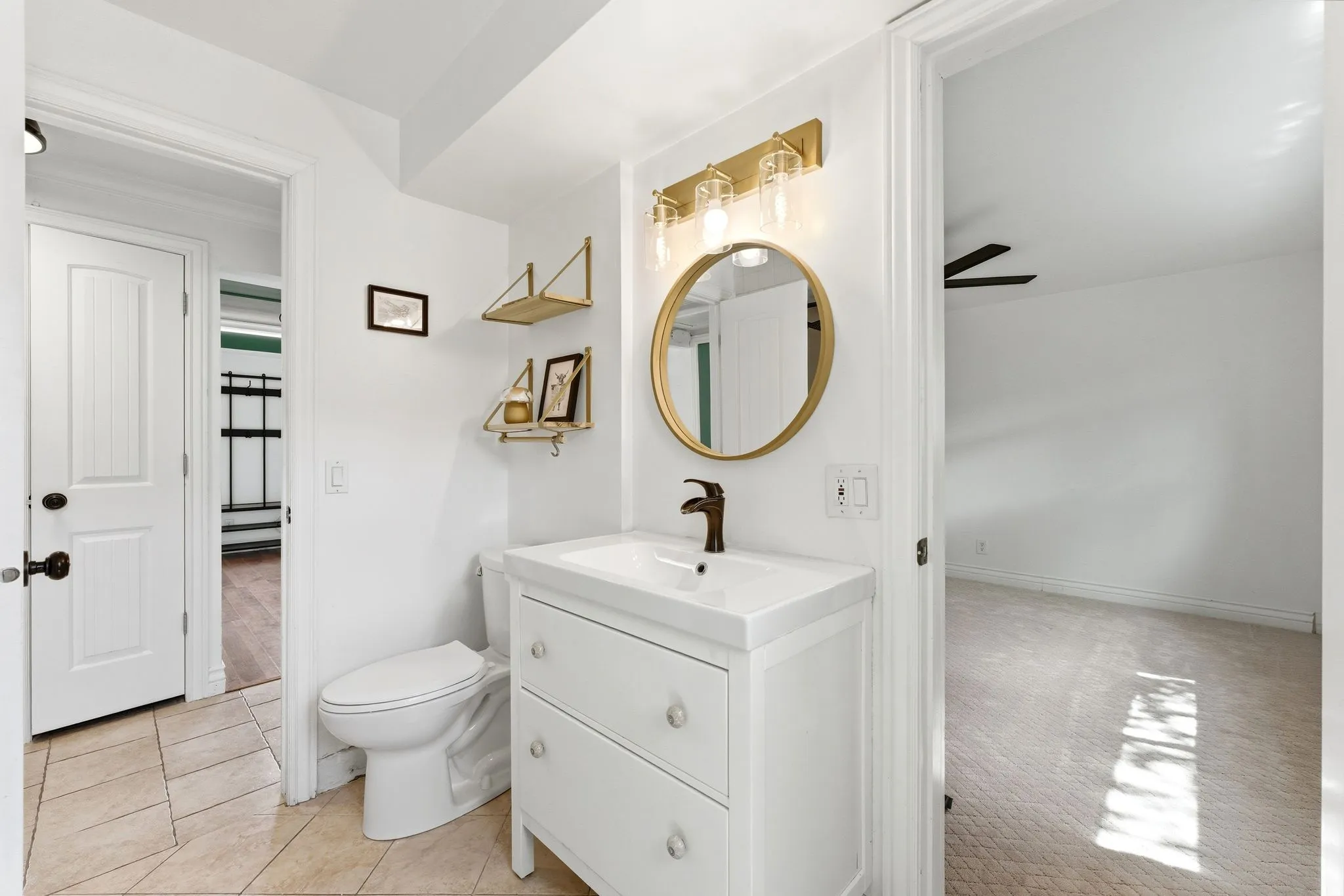 Half bathroom with vanity and light carpet