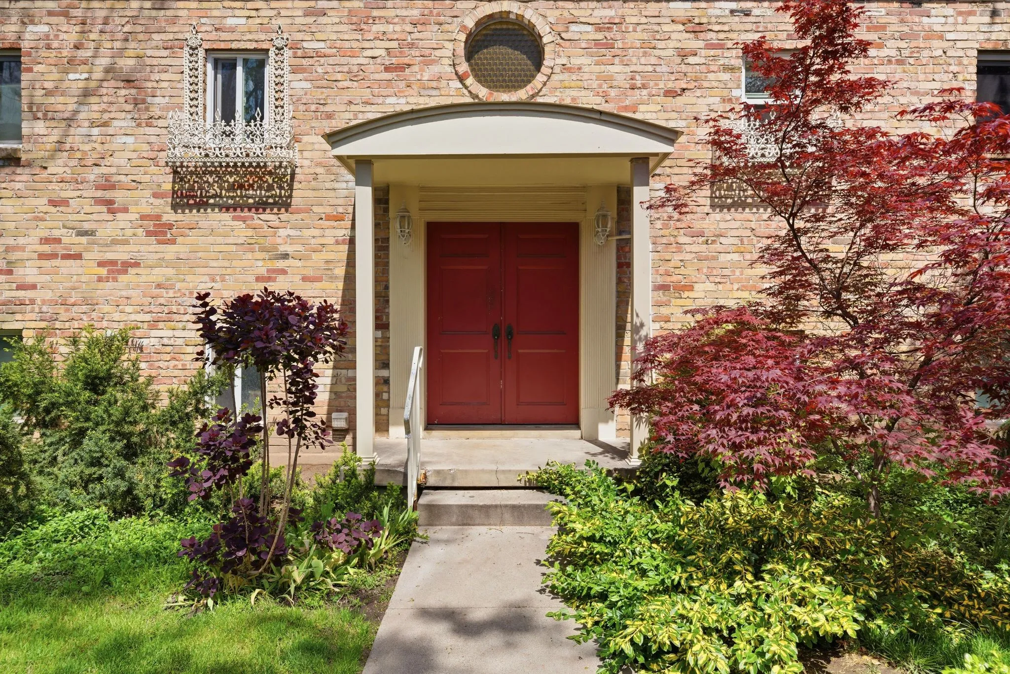 Doorway to property featuring brick siding