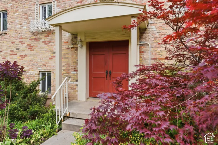 View of exterior entry with brick siding