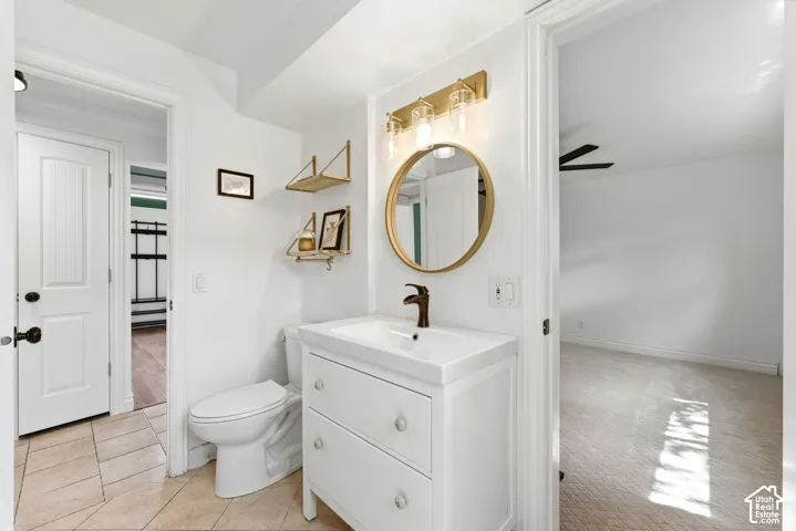 Half bathroom with vanity and light carpet
