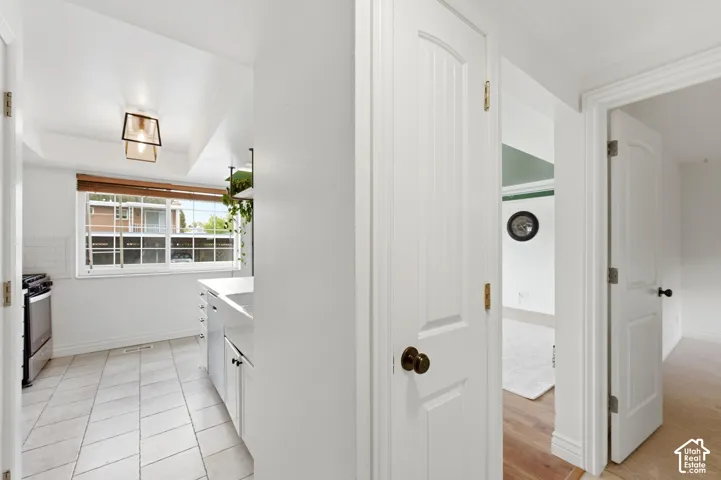 Kitchen featuring light countertops, white cabinetry, and stainless steel electric range oven