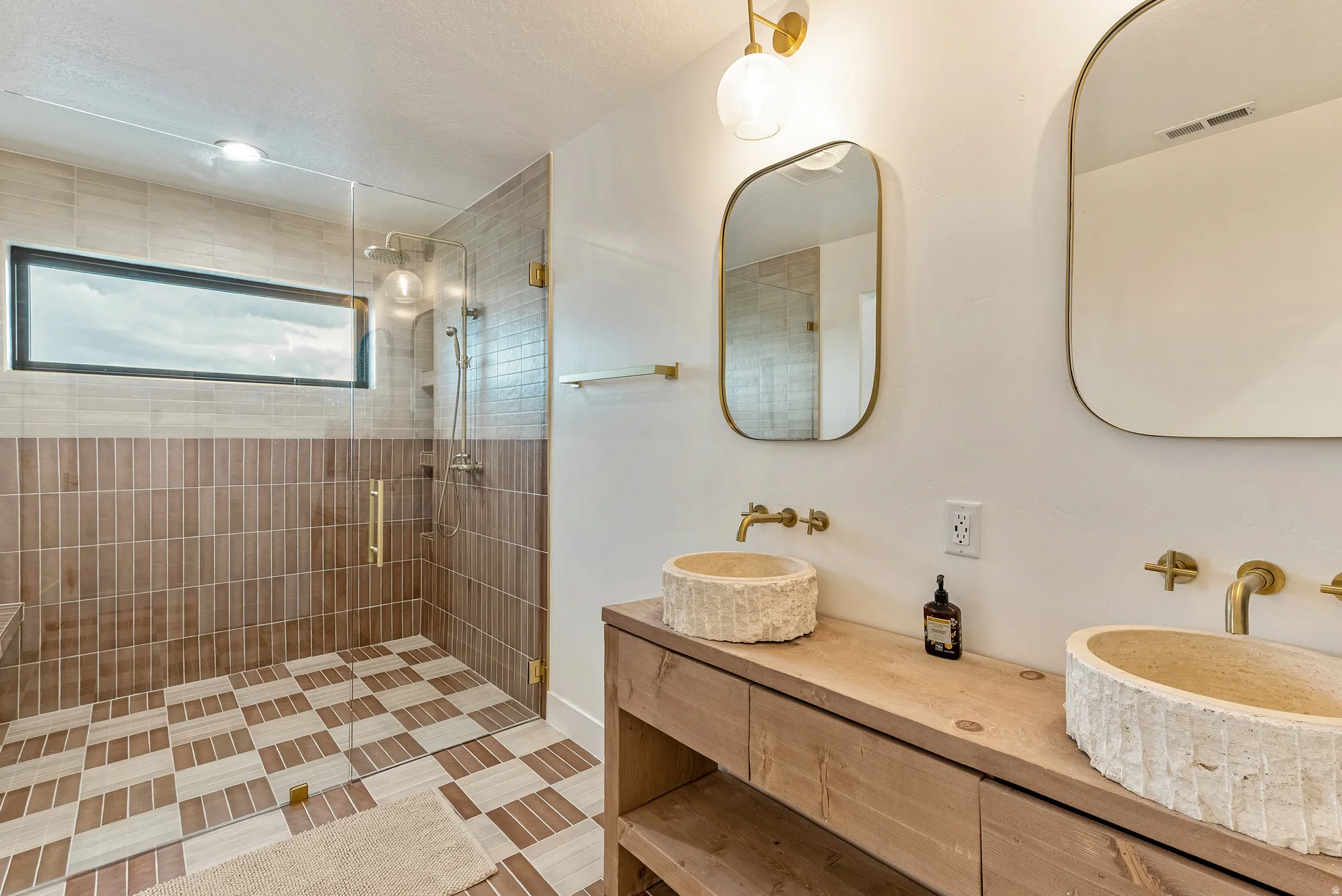 Full bath featuring double vanity and a shower stall