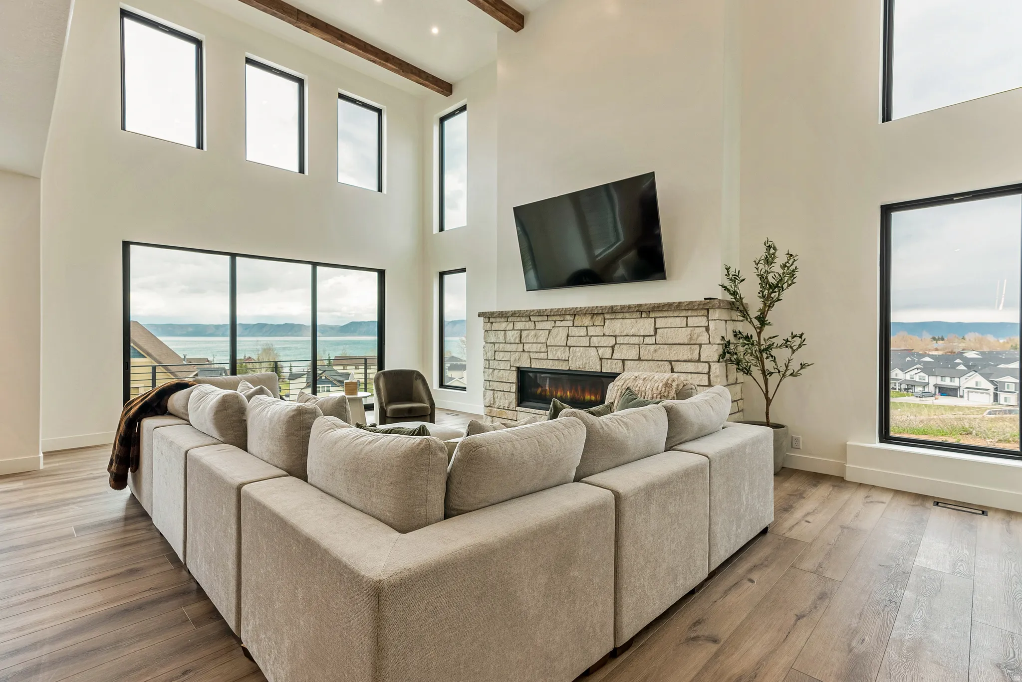 Living area featuring a stone fireplace and light wood finished floors