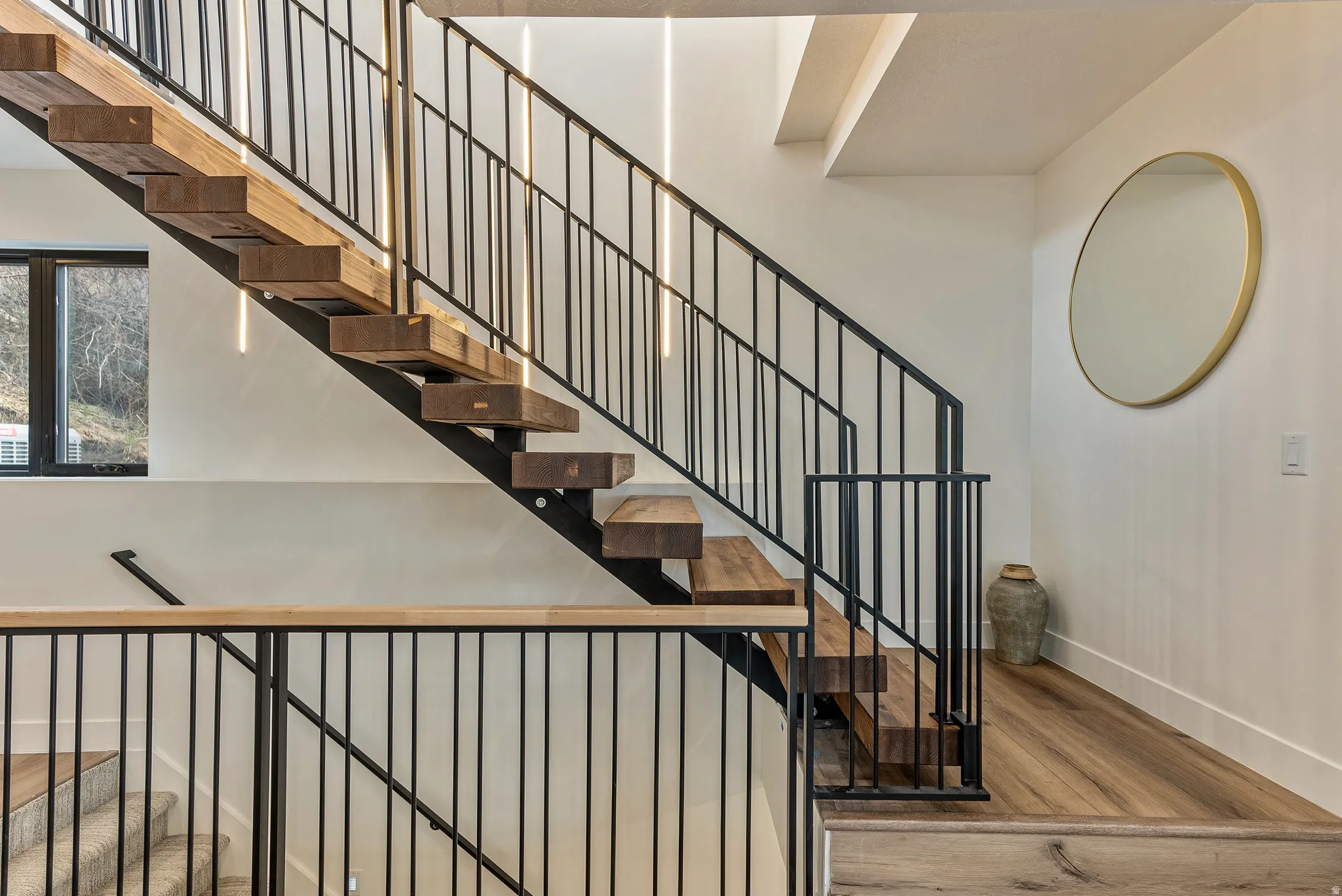 Stairway featuring wood-type flooring and baseboards