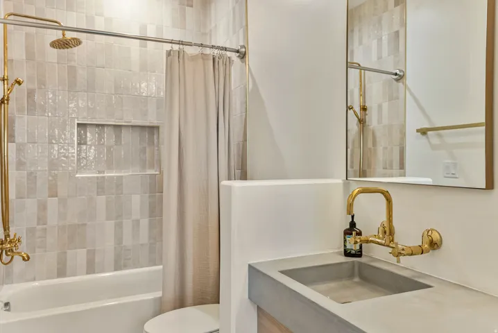 Bathroom featuring vanity and shower / bath combo with shower curtain