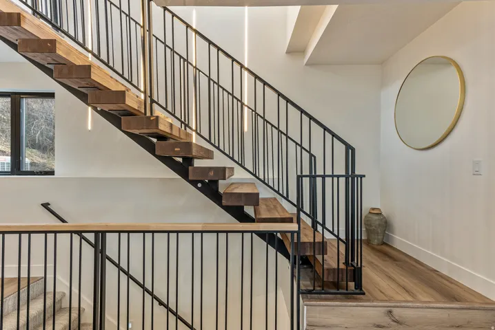 Stairway featuring wood-type flooring and baseboards