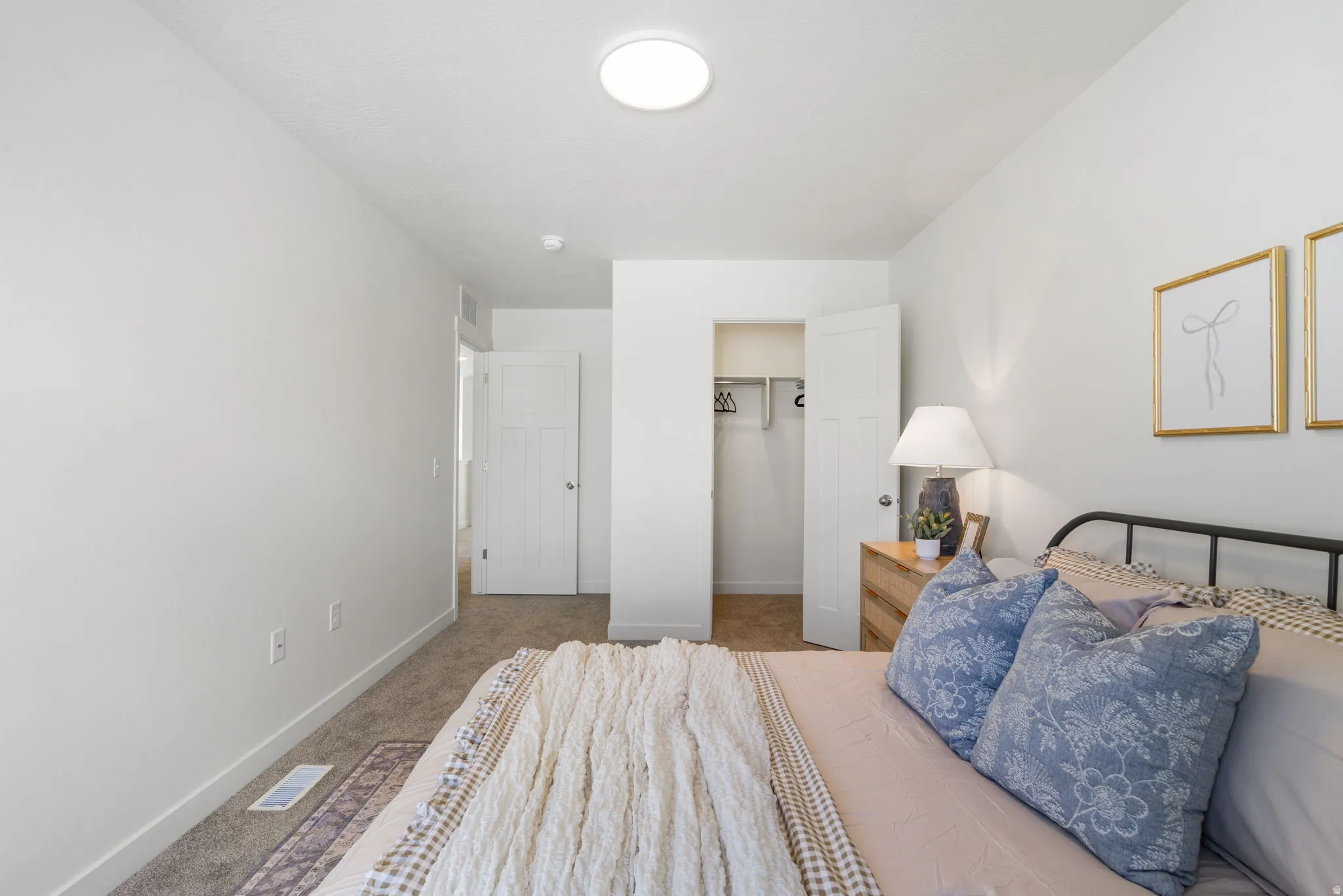 Bedroom featuring light carpet and baseboards
