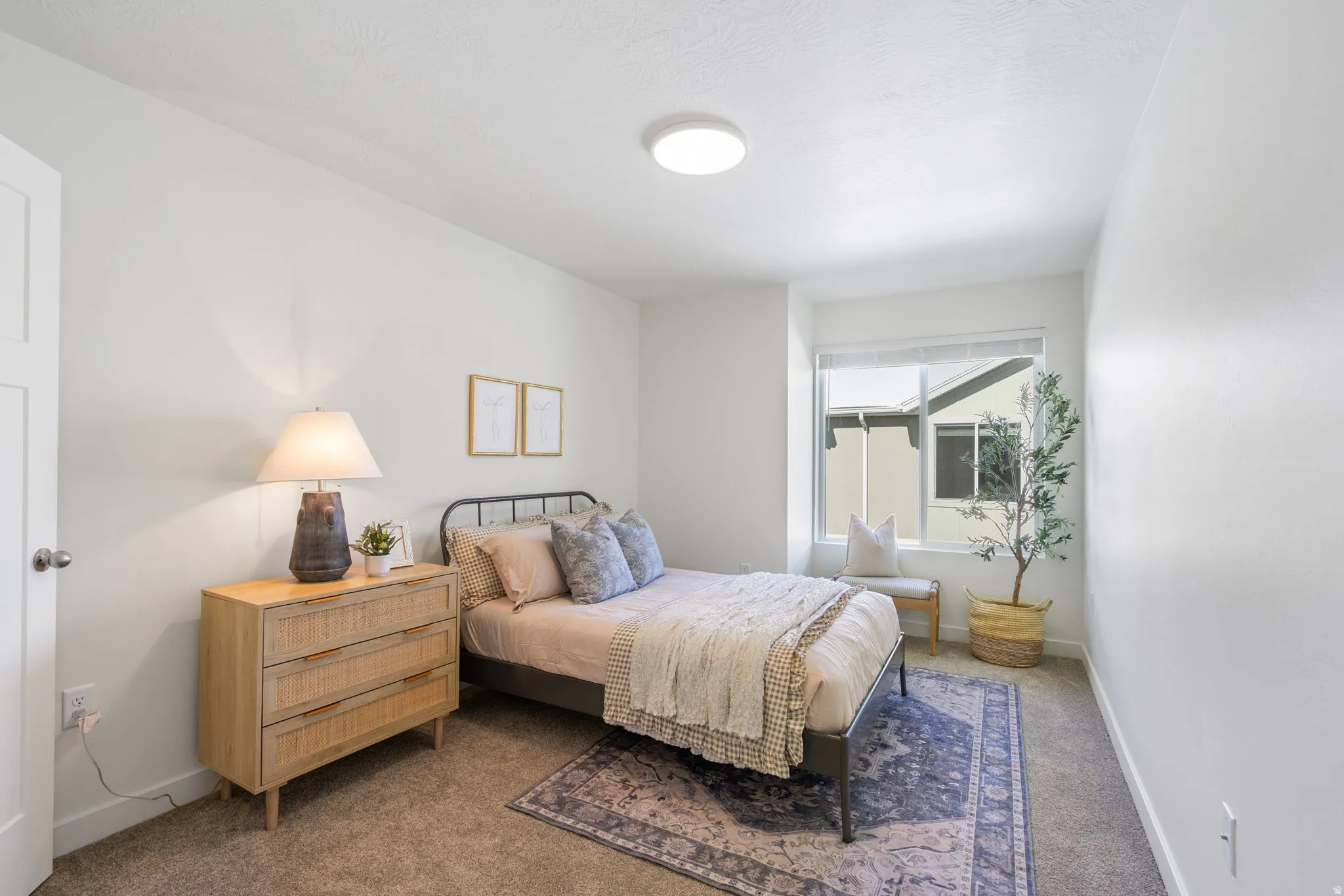 Bedroom featuring carpet and baseboards