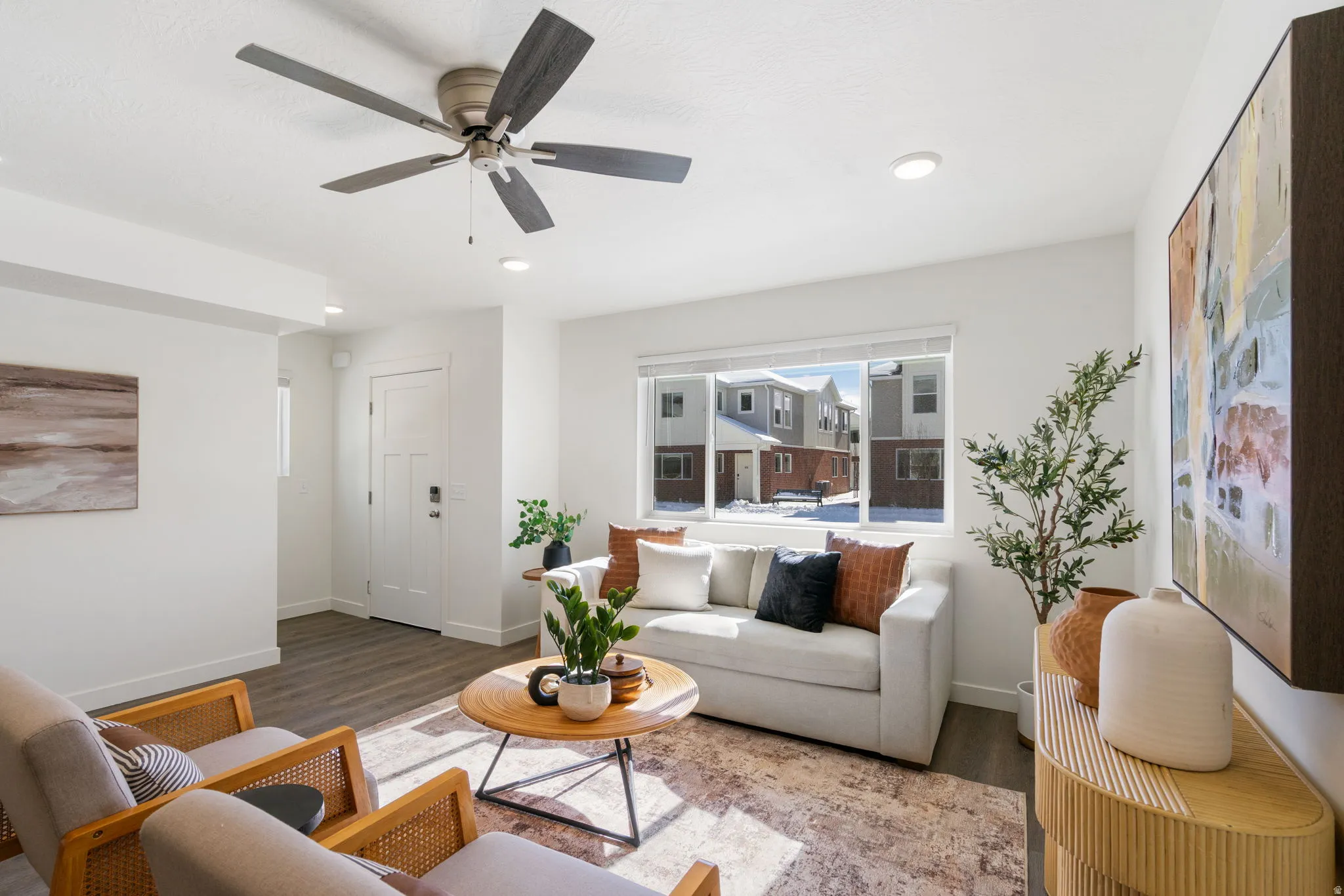 Living area with wood finished floors, ceiling fan, and recessed lighting