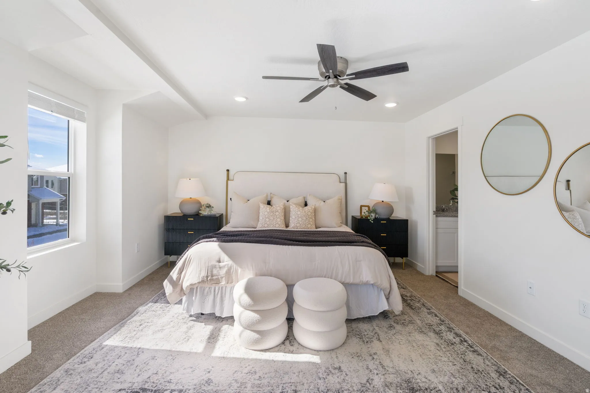 Carpeted bedroom featuring a ceiling fan and connected bathroom