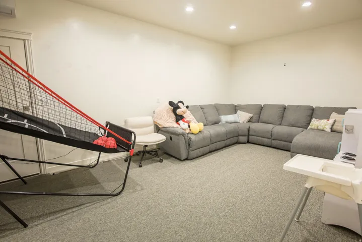 Living area featuring light carpet and recessed lighting