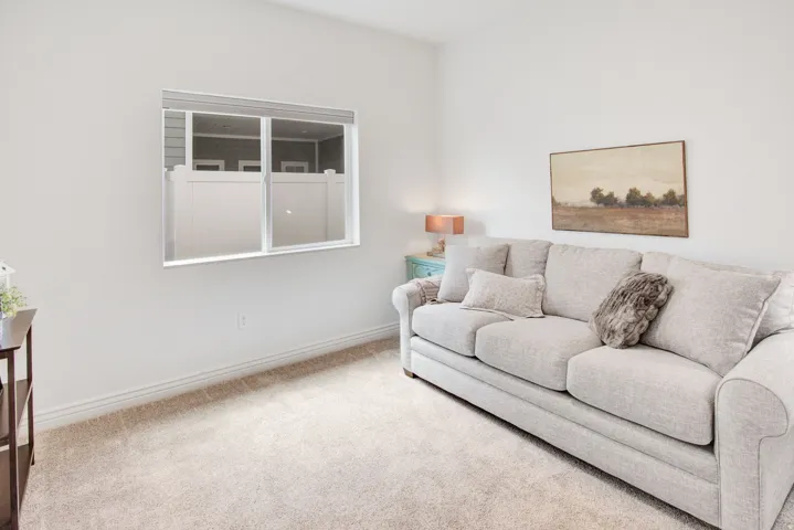 Carpeted living room with baseboards