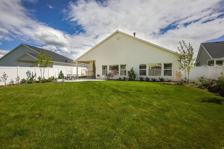 Rear view of house featuring a fenced backyard, a patio area, and stucco siding