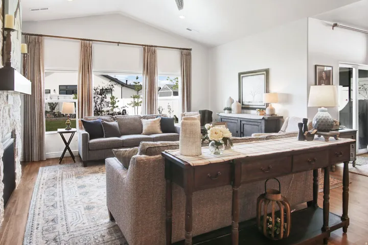 Living room featuring wood finished floors and a stone fireplace