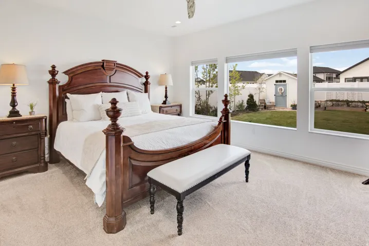 Bedroom featuring light colored carpet