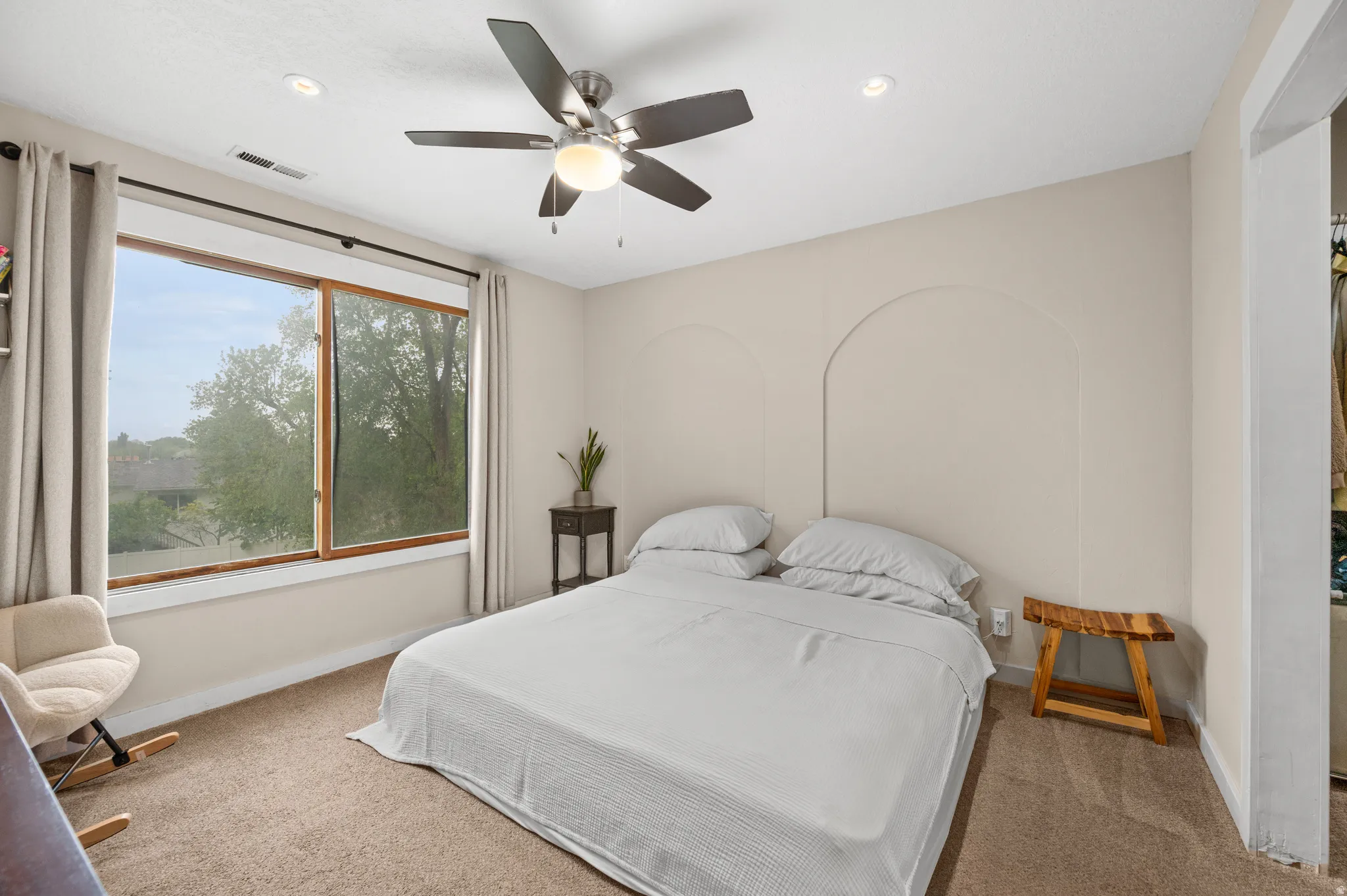 Carpeted bedroom featuring a ceiling fan and recessed lighting. Zensation.