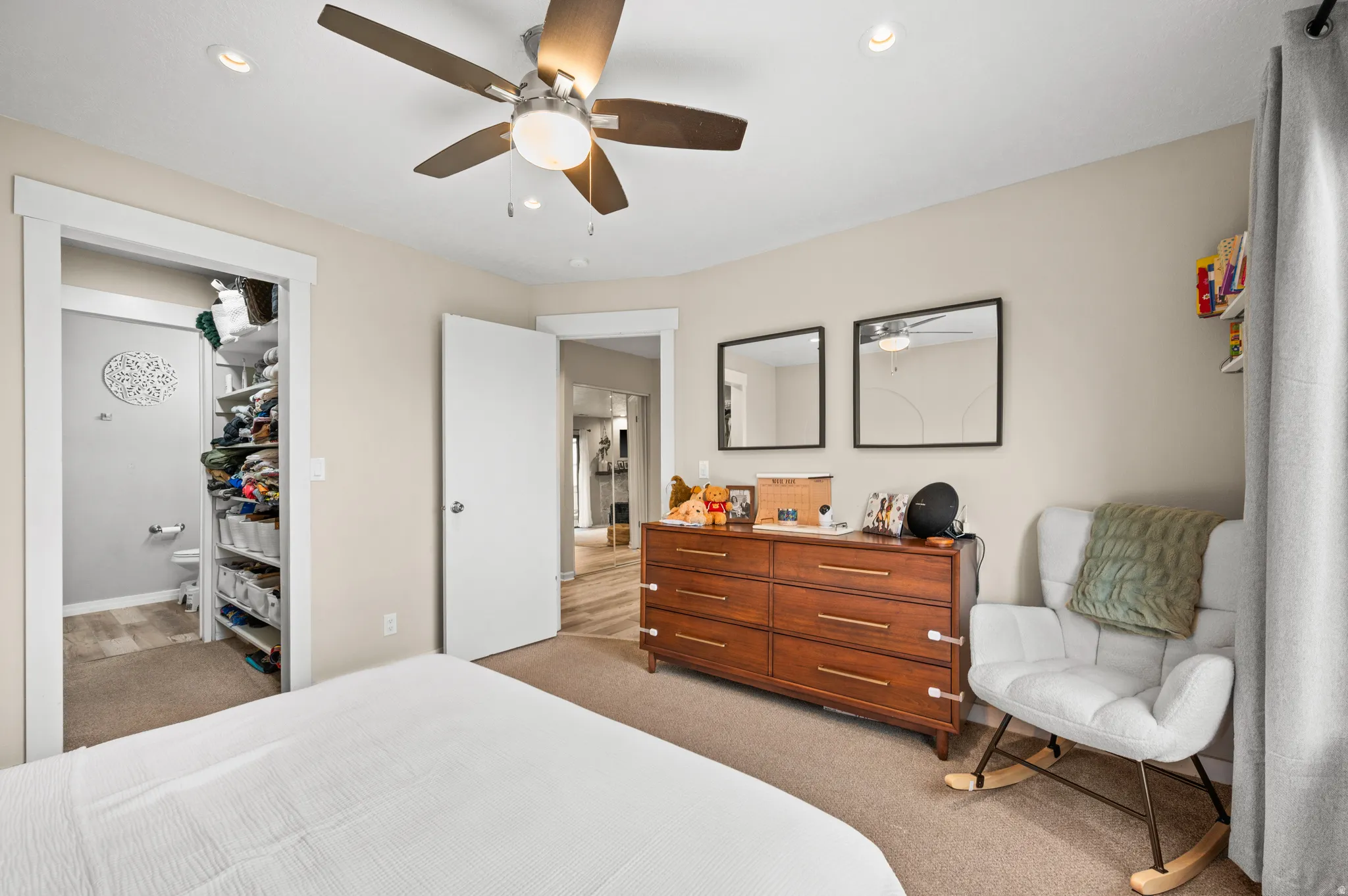 Bedroom featuring light colored carpet, ceiling fan, and recessed lighting