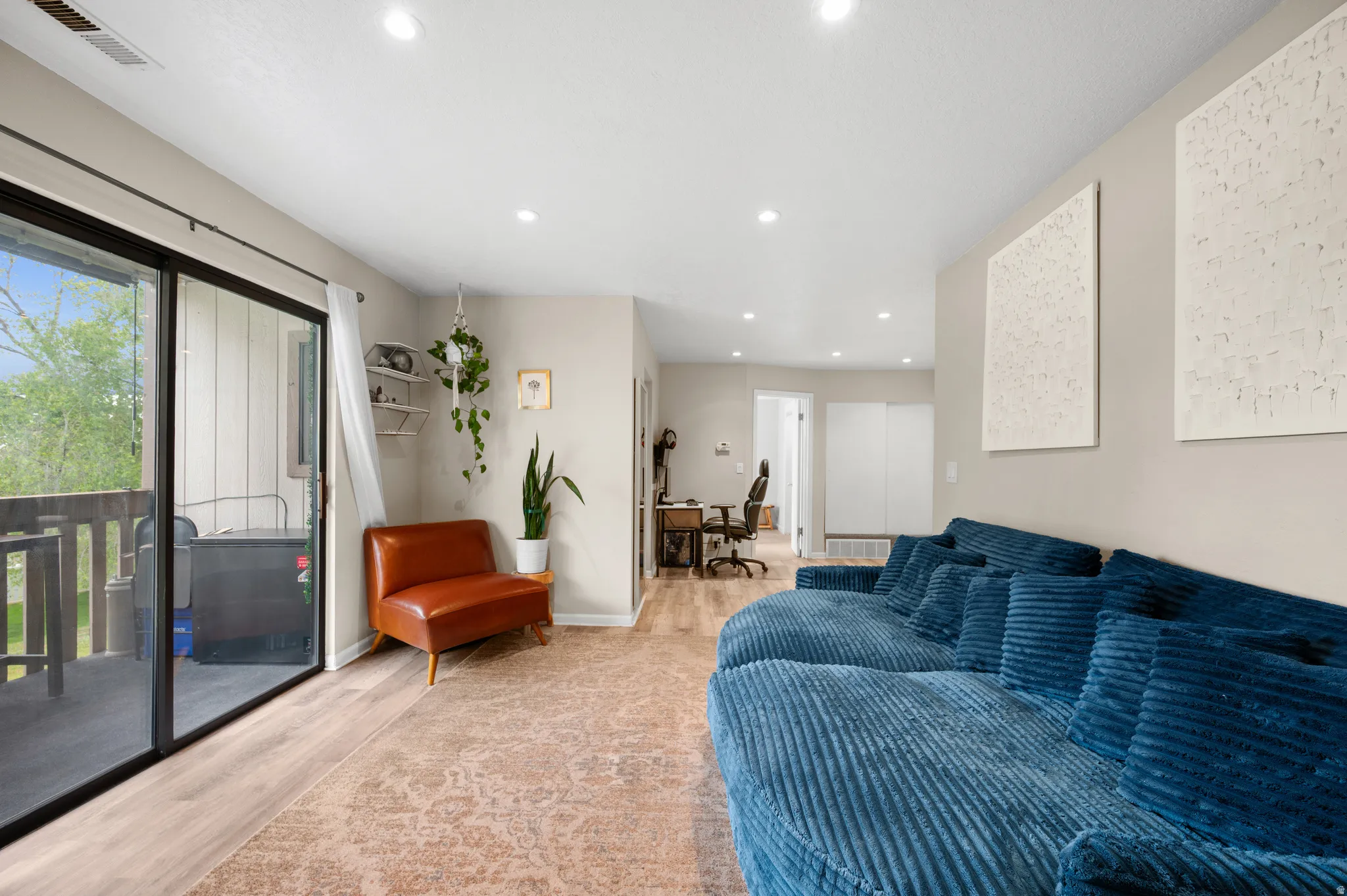 Living room with recessed lighting and light vinyl floors