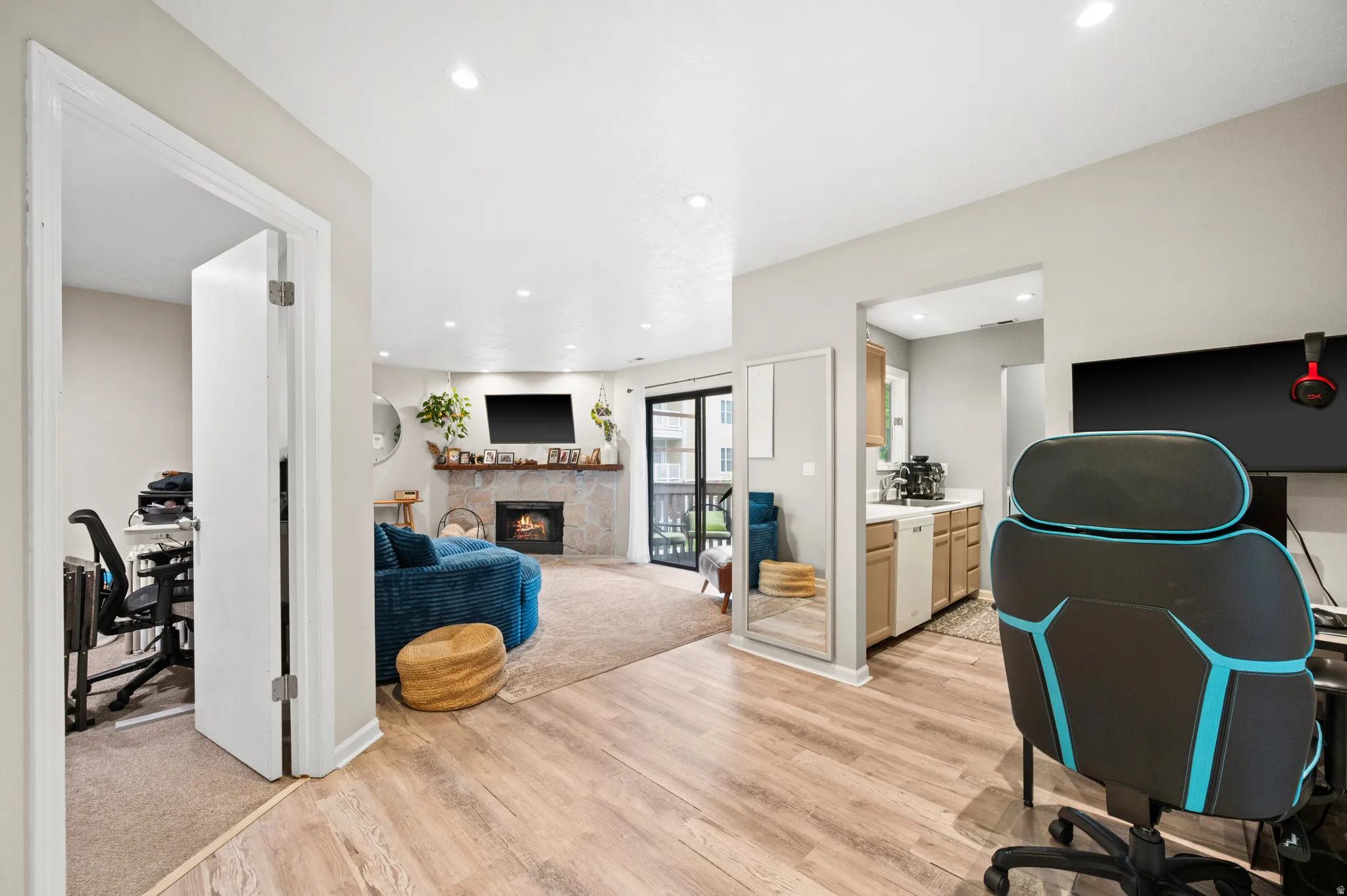 Office with light wood-type flooring, a fireplace, and recessed lighting