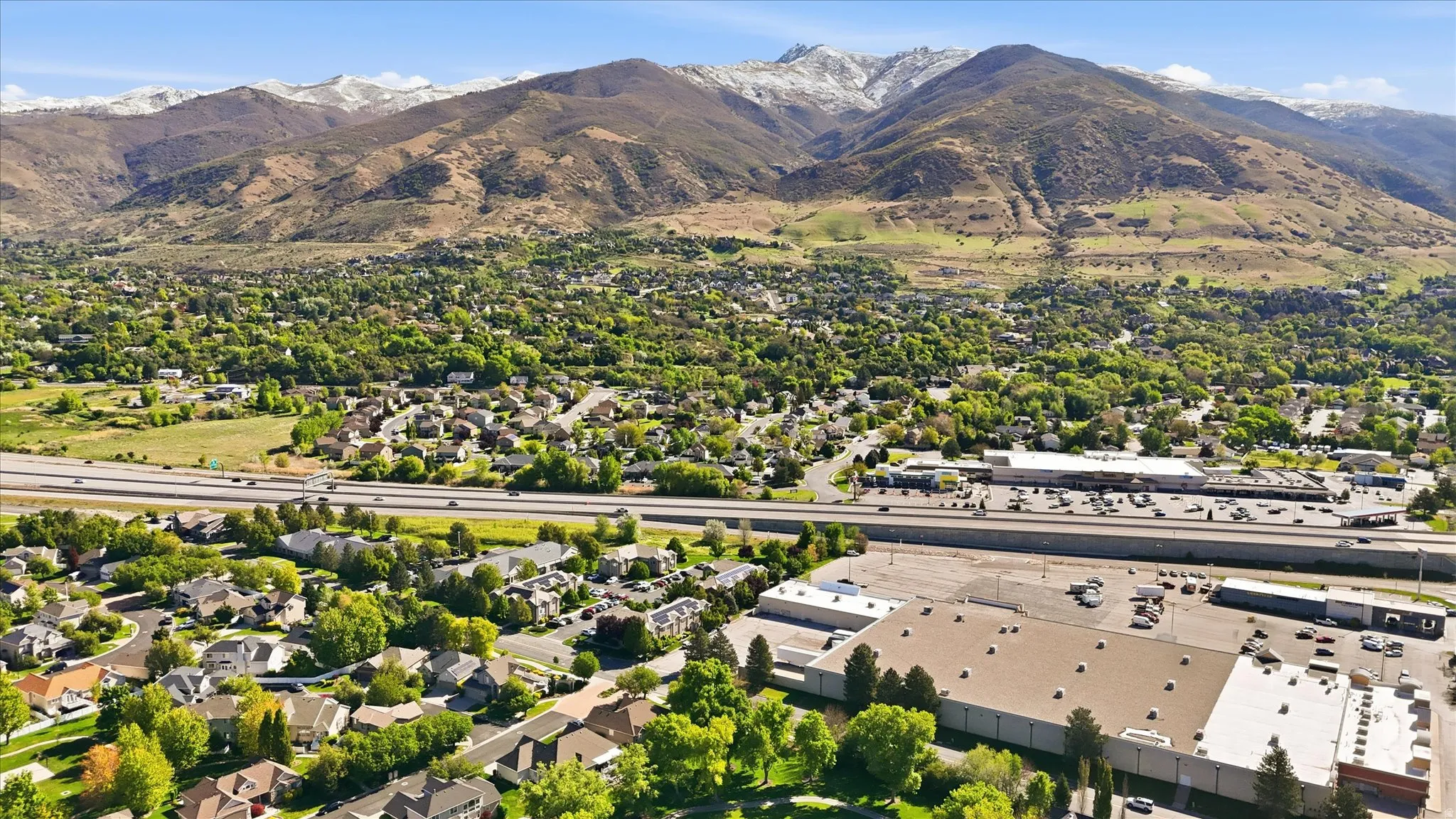 Aerial view of residential area featuring a mountain backdrop
