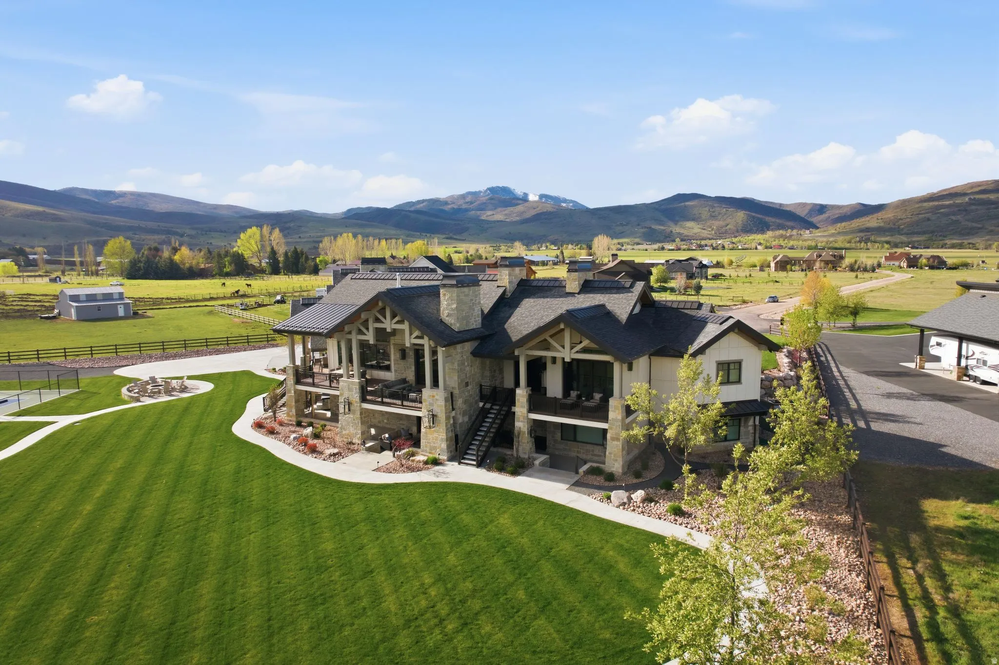Rear view of property with stone siding, a mountain view, and a view of countryside