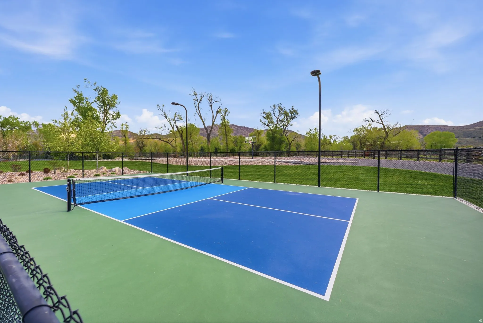 View of tennis court with a mountain view