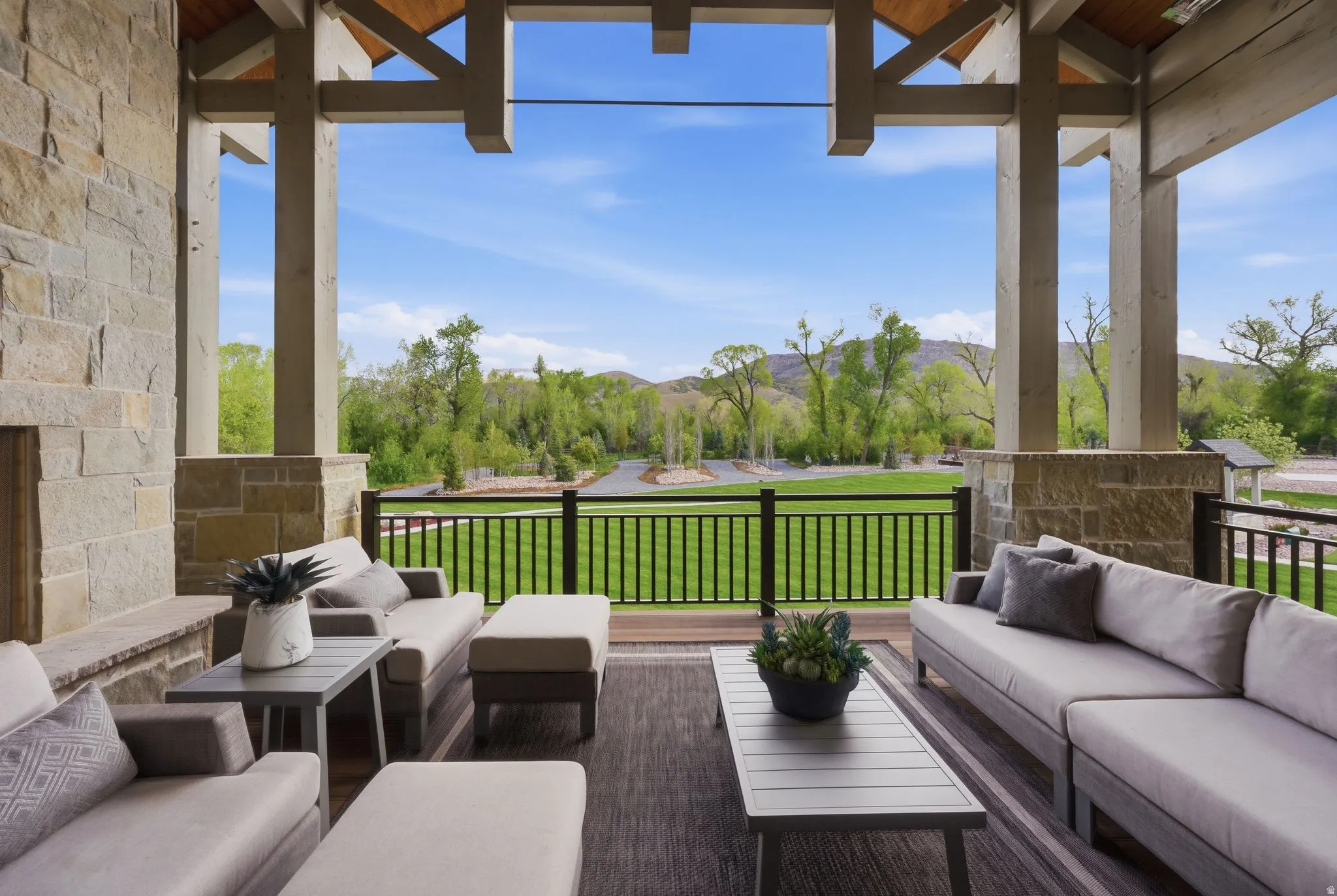 Wooden deck with outdoor furniture and a lawn