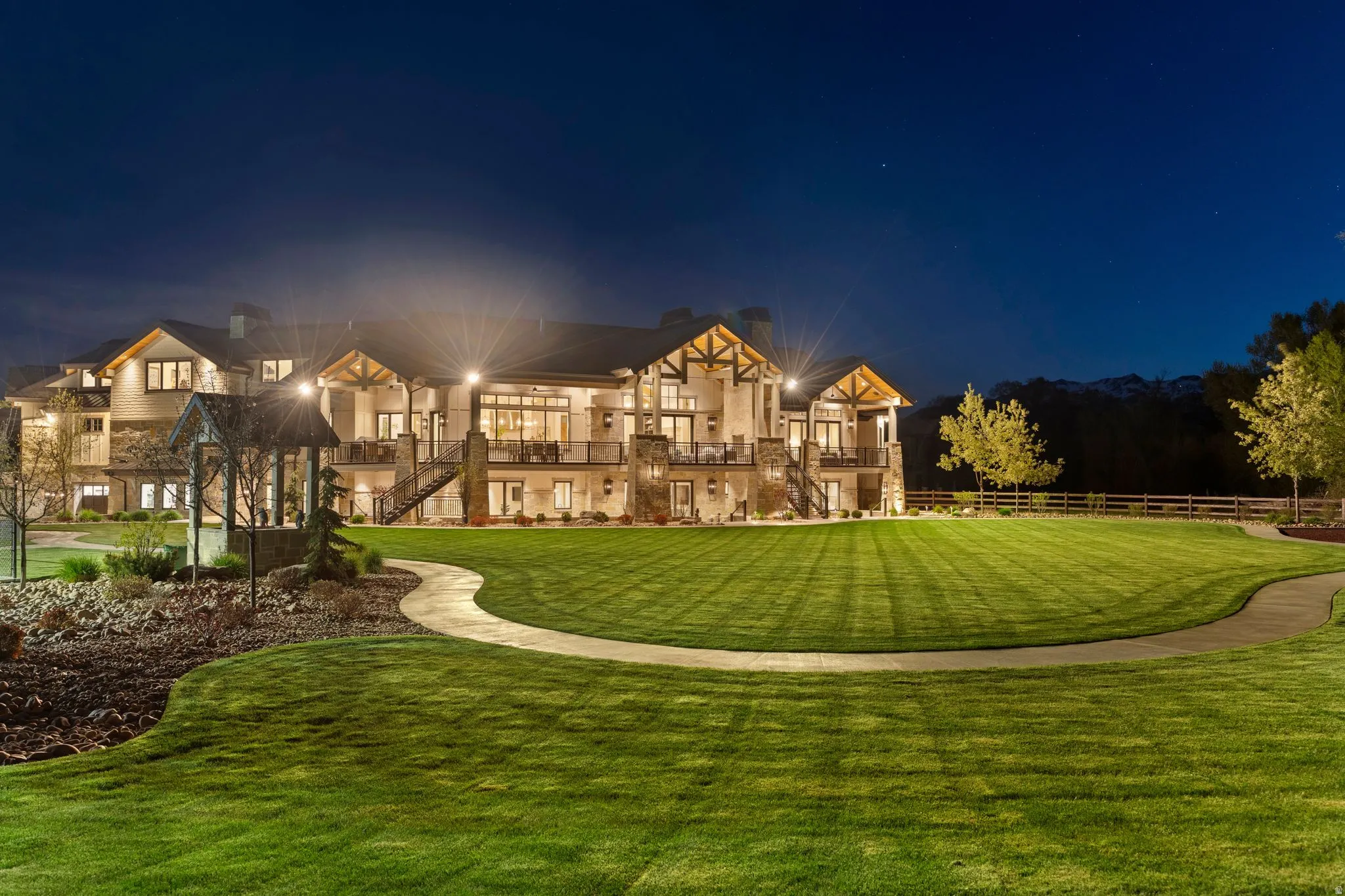 Back of house at night with a yard