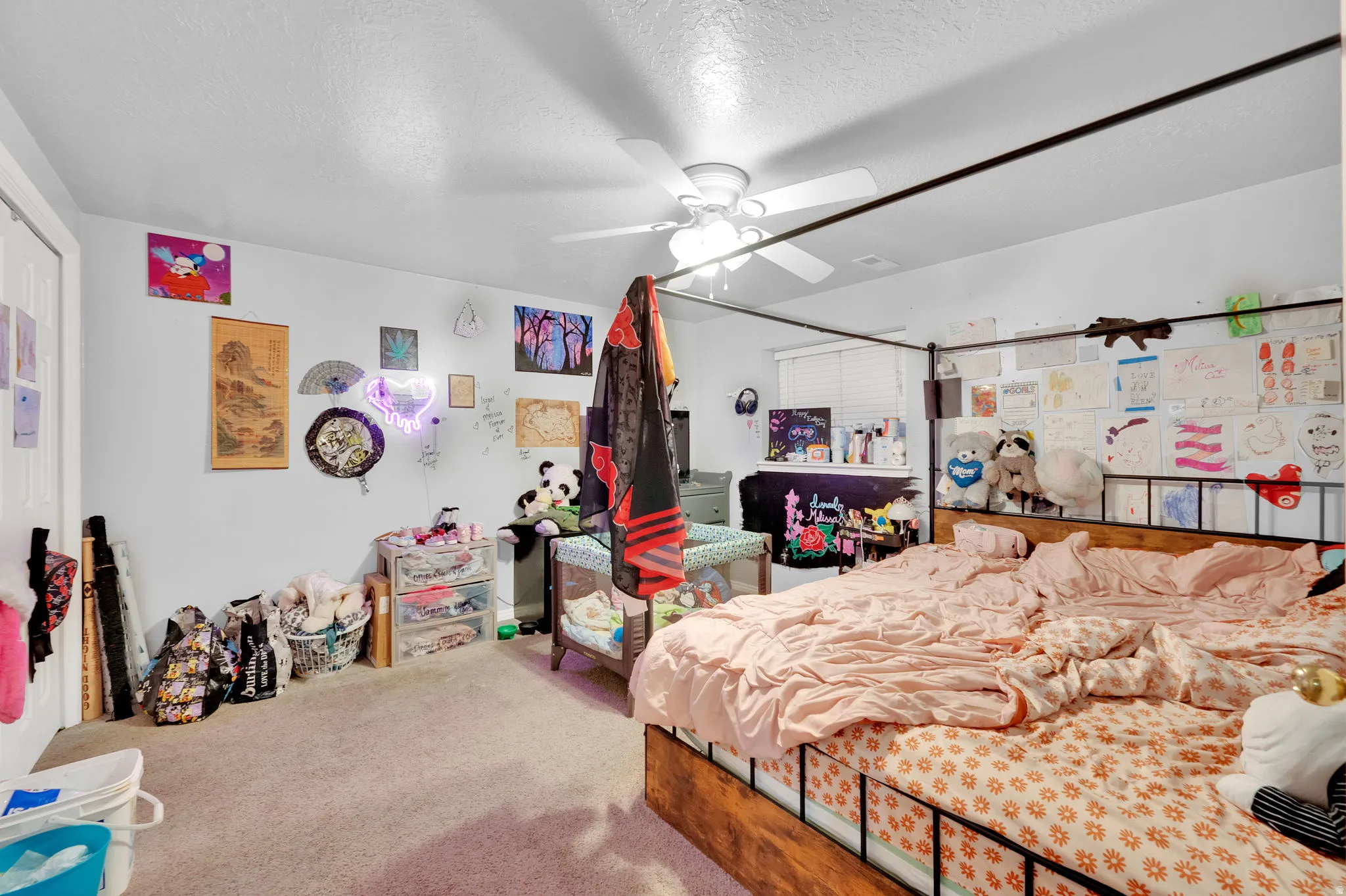 Bedroom with carpet, a textured ceiling, and ceiling fan