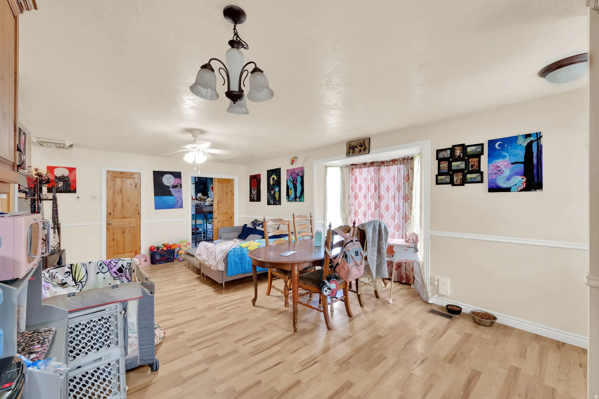 Dining room with light wood-style floors and a ceiling fan