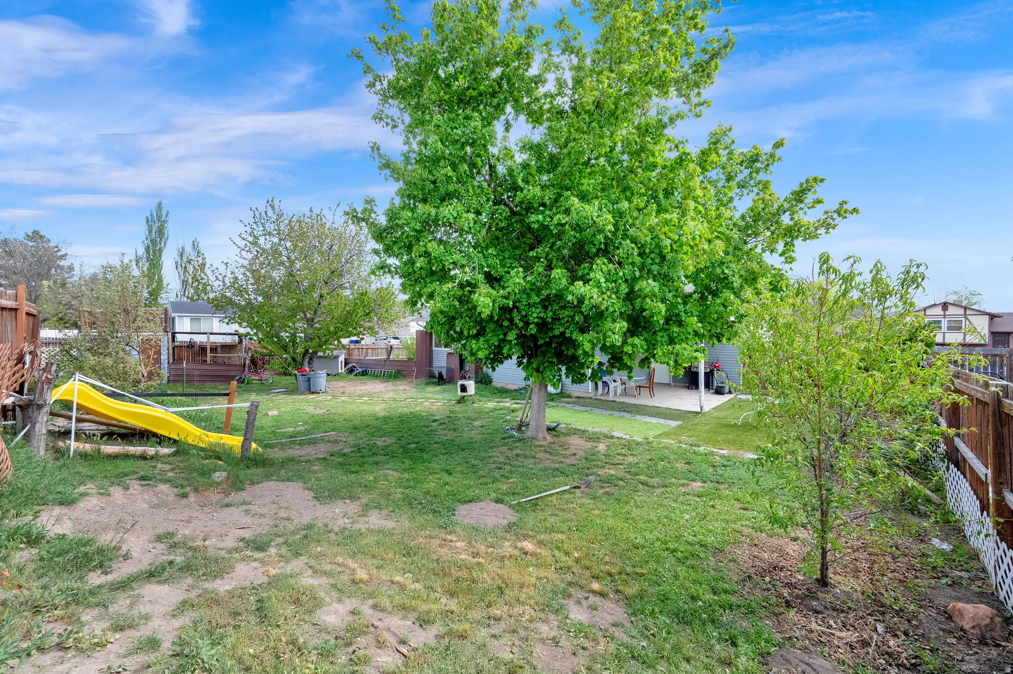 View of yard with a playground and a patio area