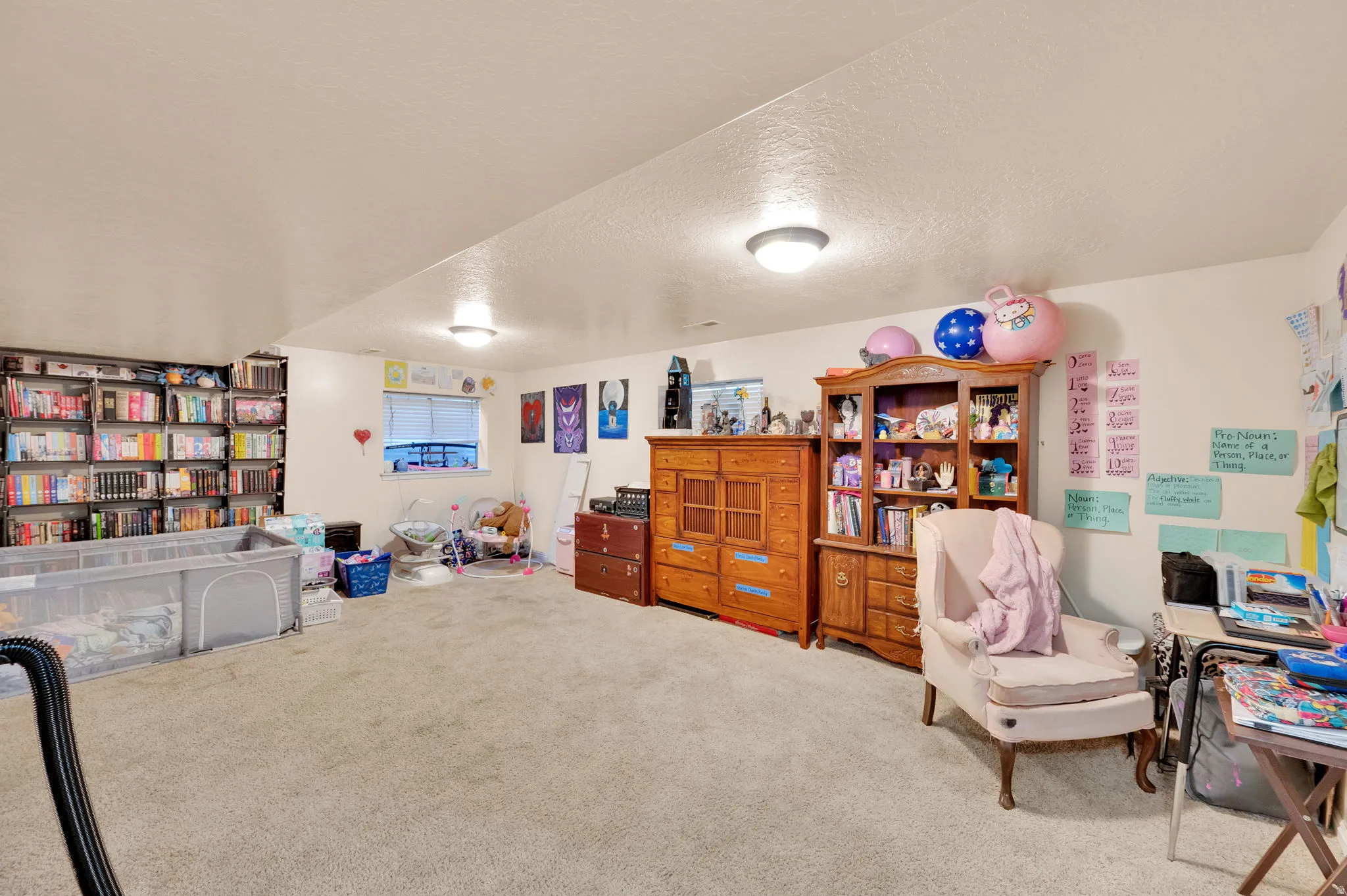 Sitting room with a textured ceiling and carpet