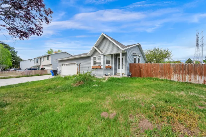 View of front of home featuring an attached garage and concrete driveway