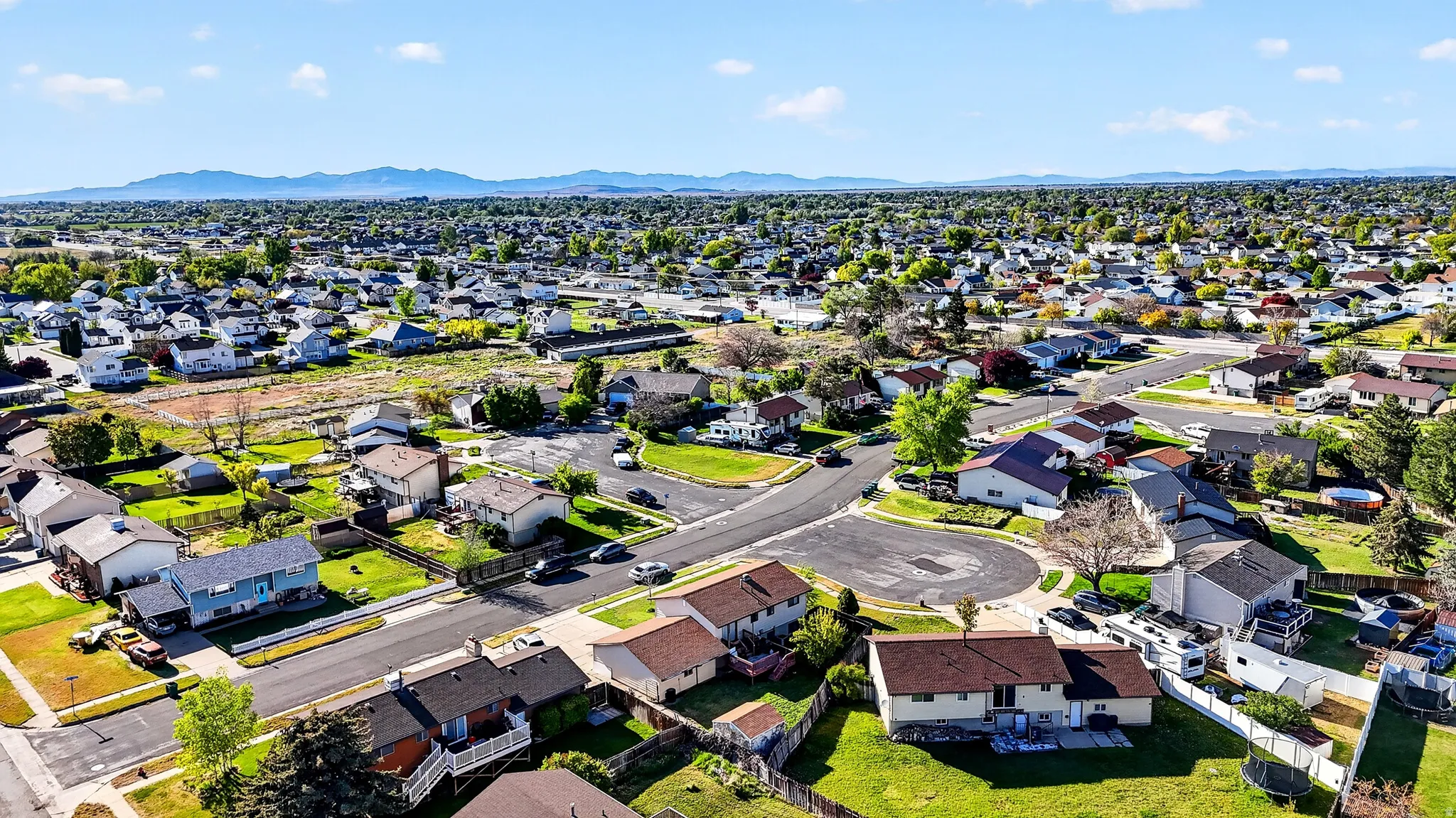 Aerial perspective of suburban area with a mountainous background