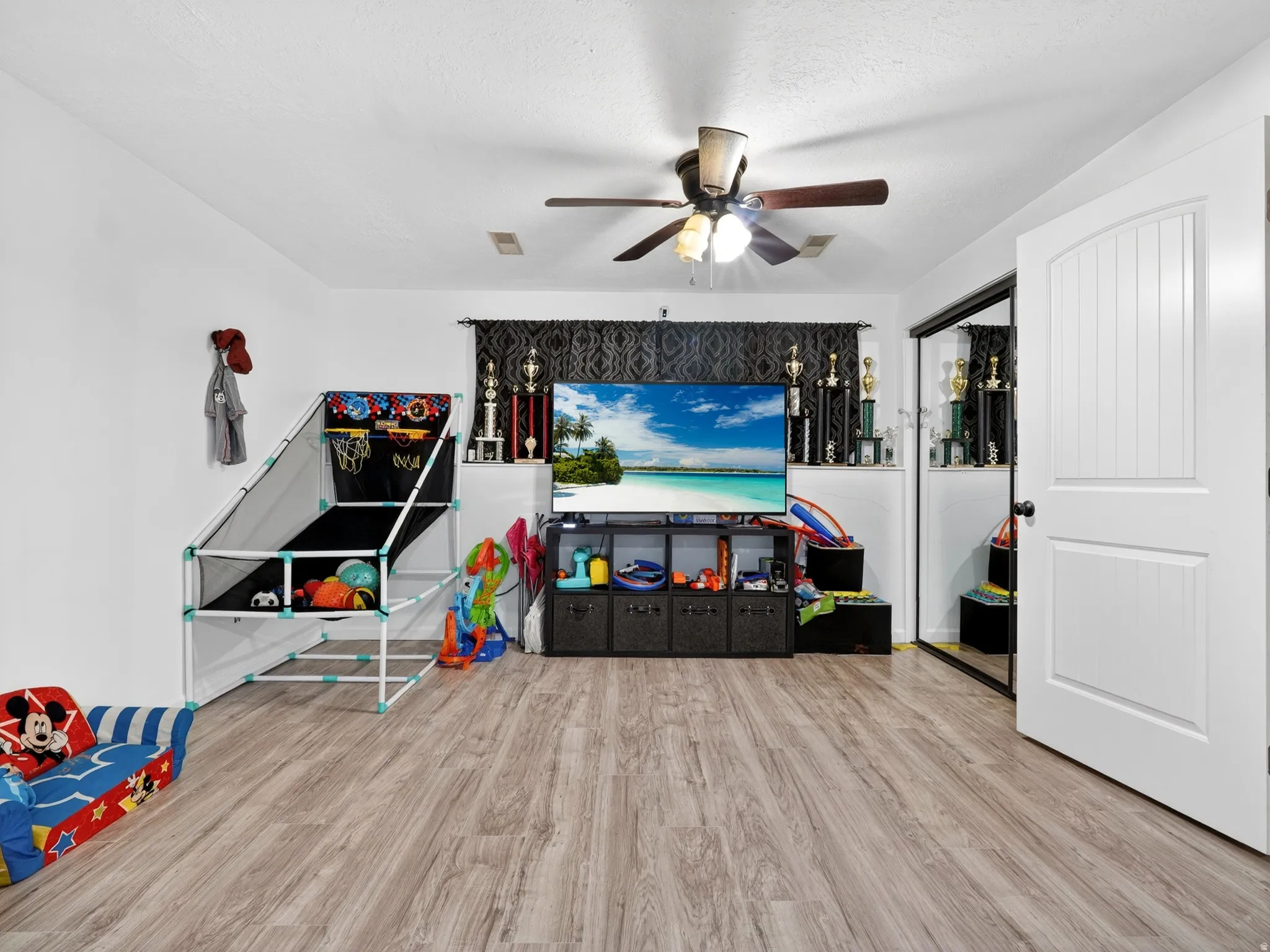 Playroom featuring light wood finished floors and ceiling fan