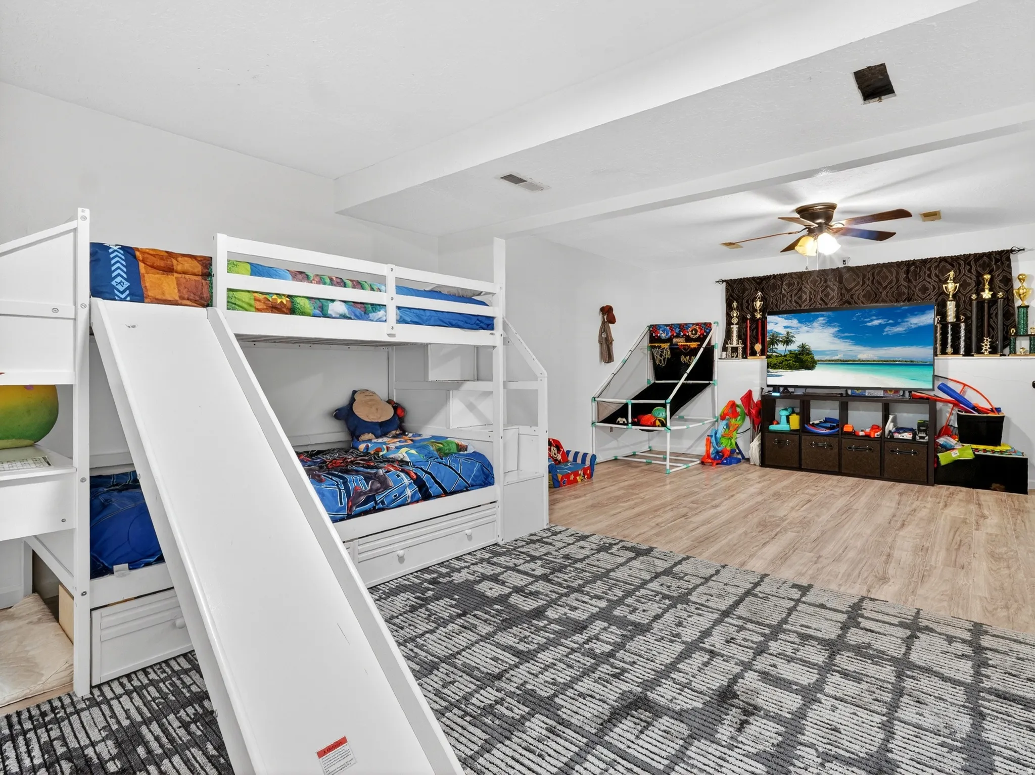 Bedroom with light wood finished floors and a ceiling fan