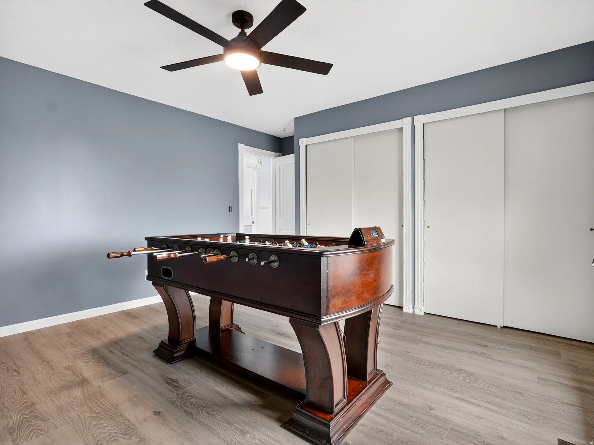 Playroom featuring light wood-style floors and a ceiling fan