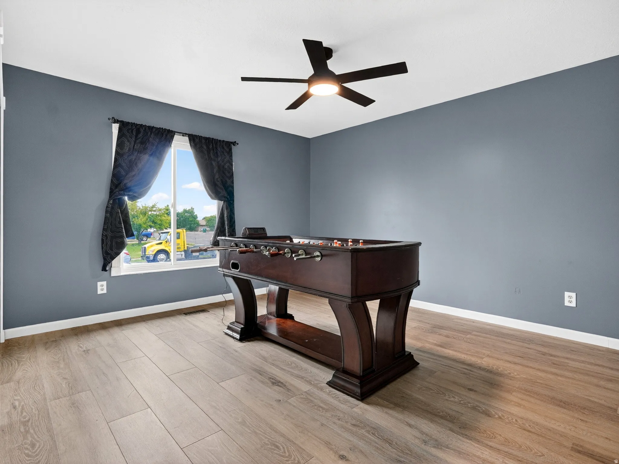 Game room featuring light wood-style flooring and ceiling fan
