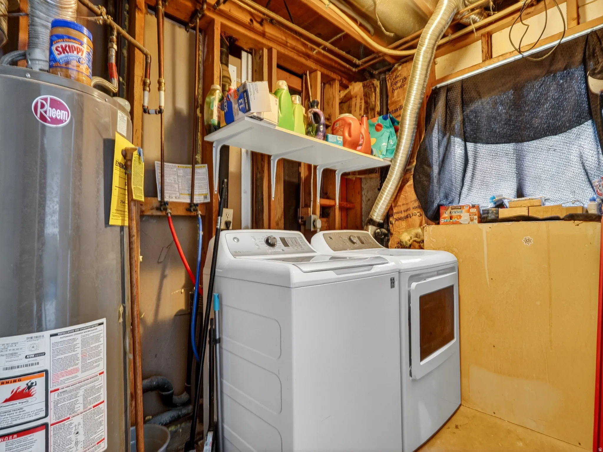 Laundry area featuring water heater and independent washer and dryer