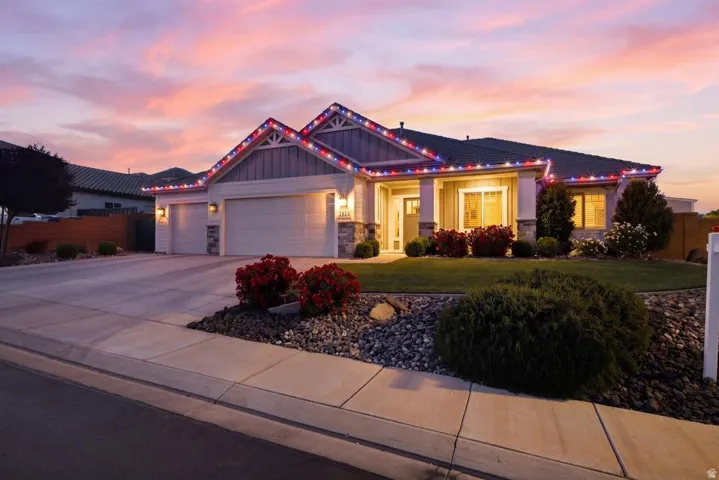 Craftsman inspired home with a garage, driveway, and board and batten siding