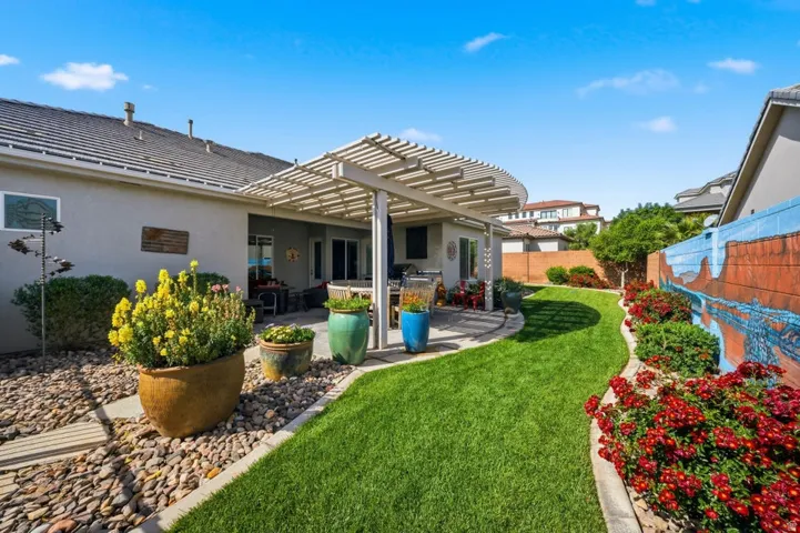 Back of house with a patio, a pergola, stucco siding, and a fenced backyard