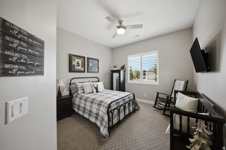 Bedroom with carpet and ceiling fan