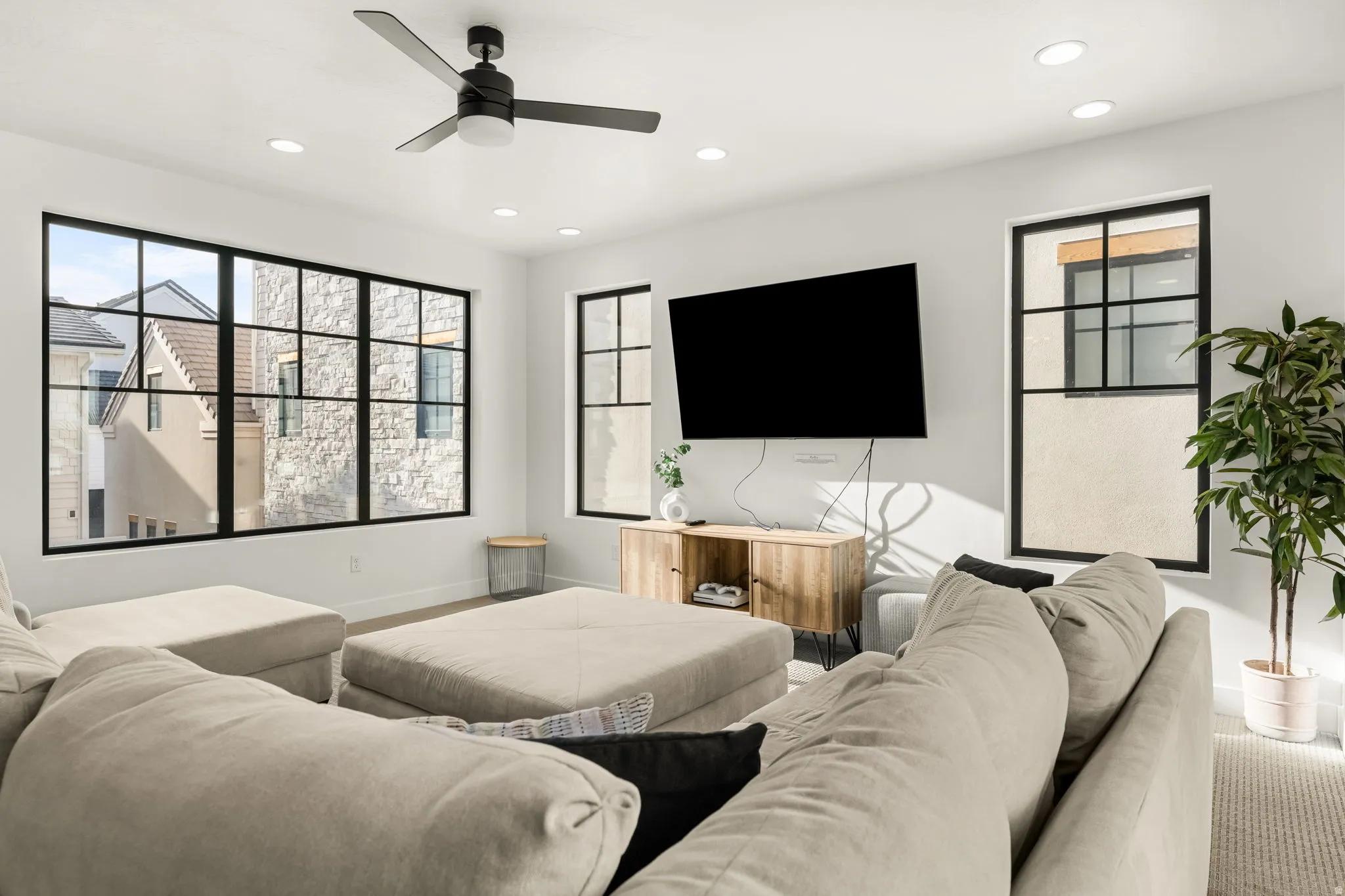 Living area with a ceiling fan, recessed lighting, and healthy amount of natural light