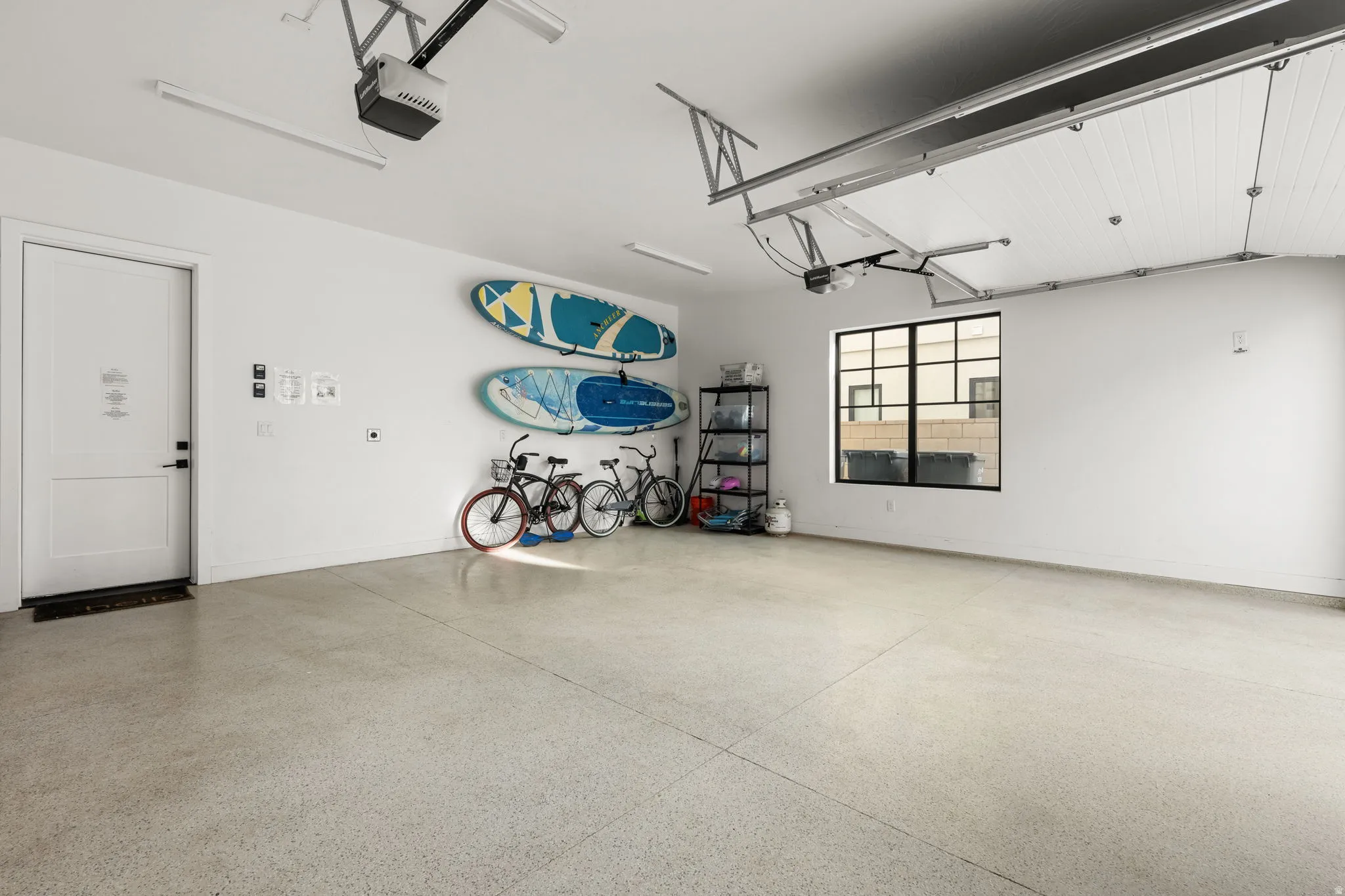 Garage with a garage door opener and baseboards