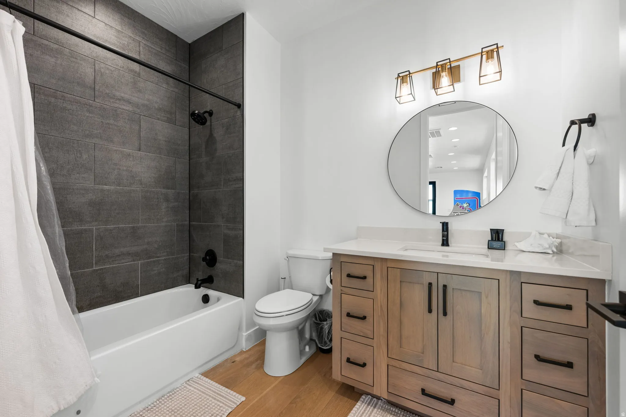 Bathroom featuring vanity, light wood-style flooring, and shower / tub combo with curtain