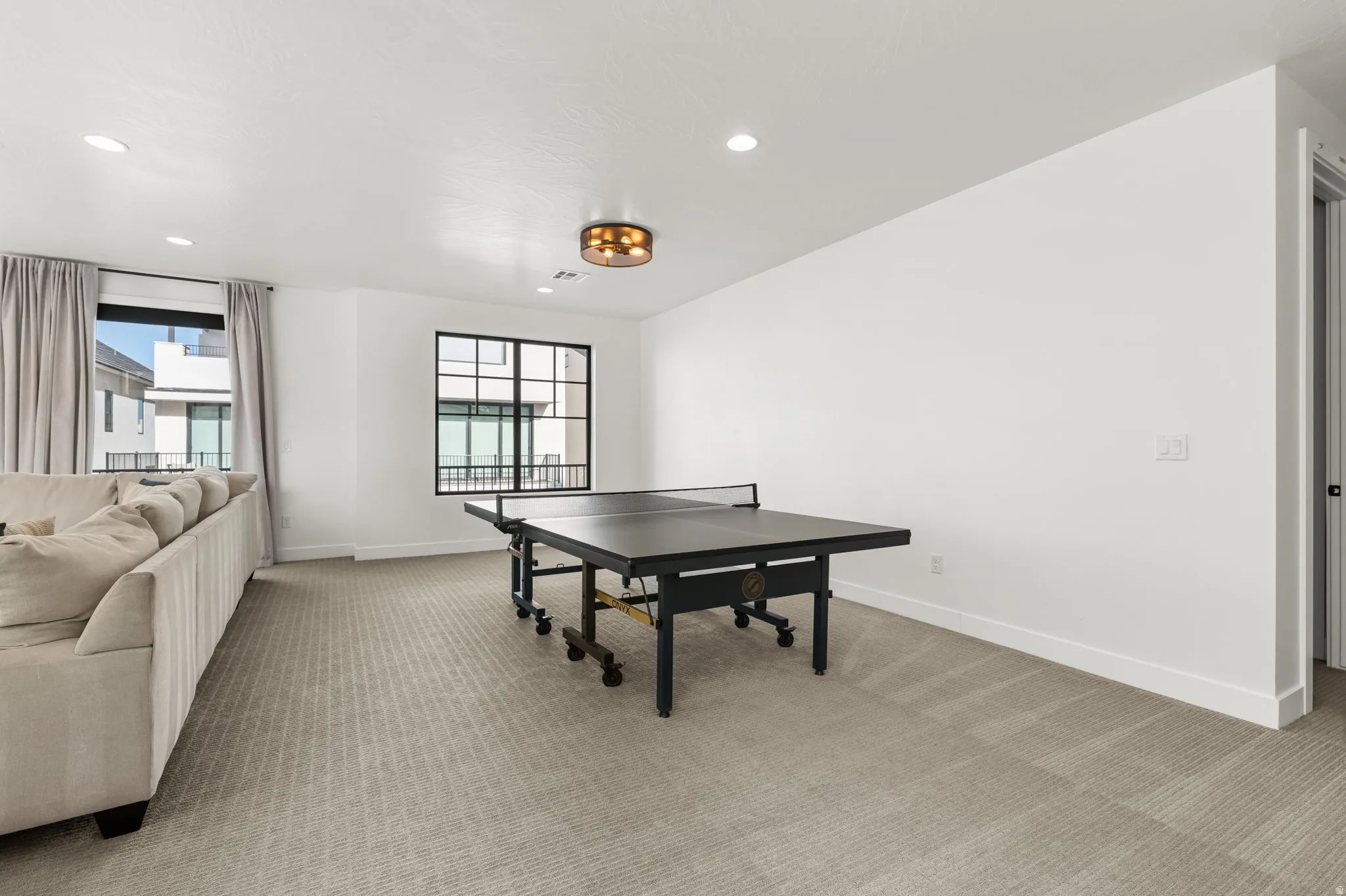 Playroom with light carpet, plenty of natural light, and recessed lighting