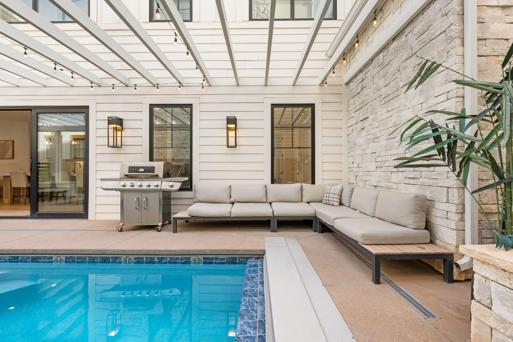 Swimming pool featuring grilling area, a patio area, outdoor seating, and a pergola